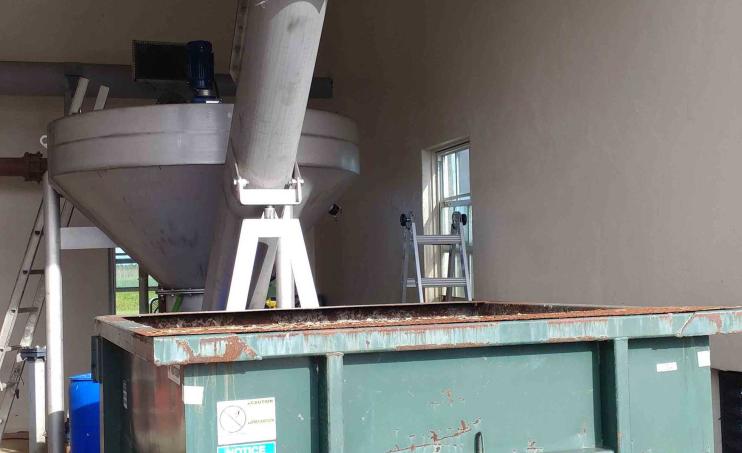 Discharging into grit dumpster